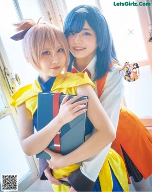 A couple of young women sitting on top of a couch.