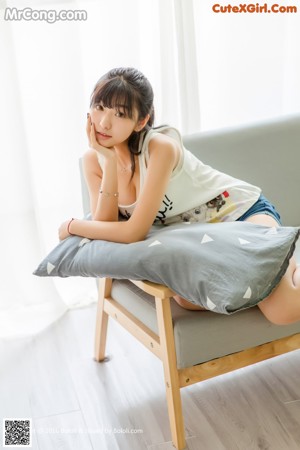 A woman laying on a bed with her legs up.