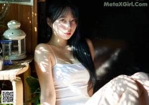 A woman in a white bodysuit sitting on a brown couch.