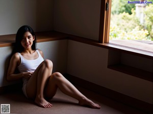 A woman sitting on top of a white couch.