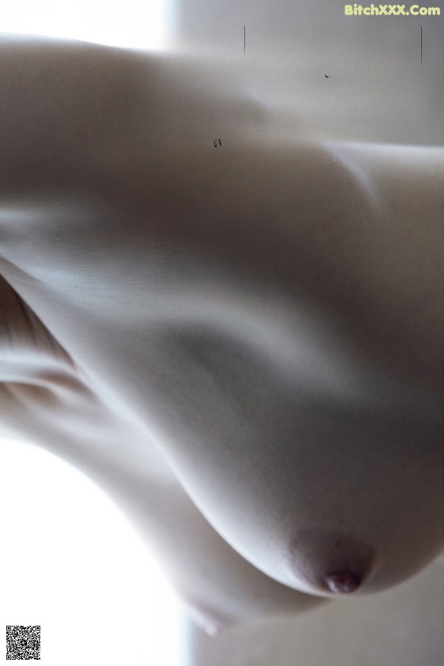 A close up of a naked woman's breasts on a magazine page.
