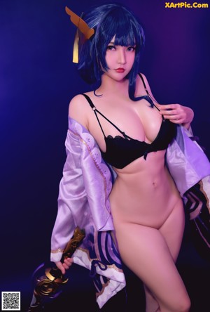 A woman in a black bikini holding a sword.