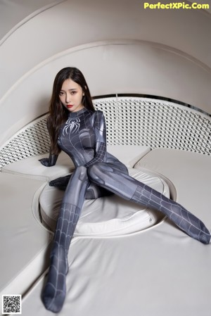 A woman in a wet suit standing in a pool.