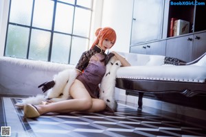 A woman sitting on a window sill with a teddy bear.