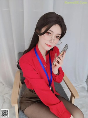 A woman in a red lingerie sitting in a chair.